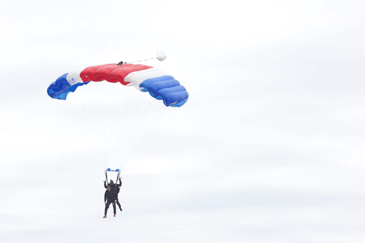 Former US President George H.W. Bush jump out of a helicopter and parachutes down to St. Anne's Episcopal Church.