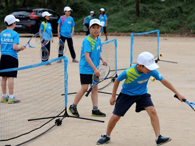 Children participate in a tennis program