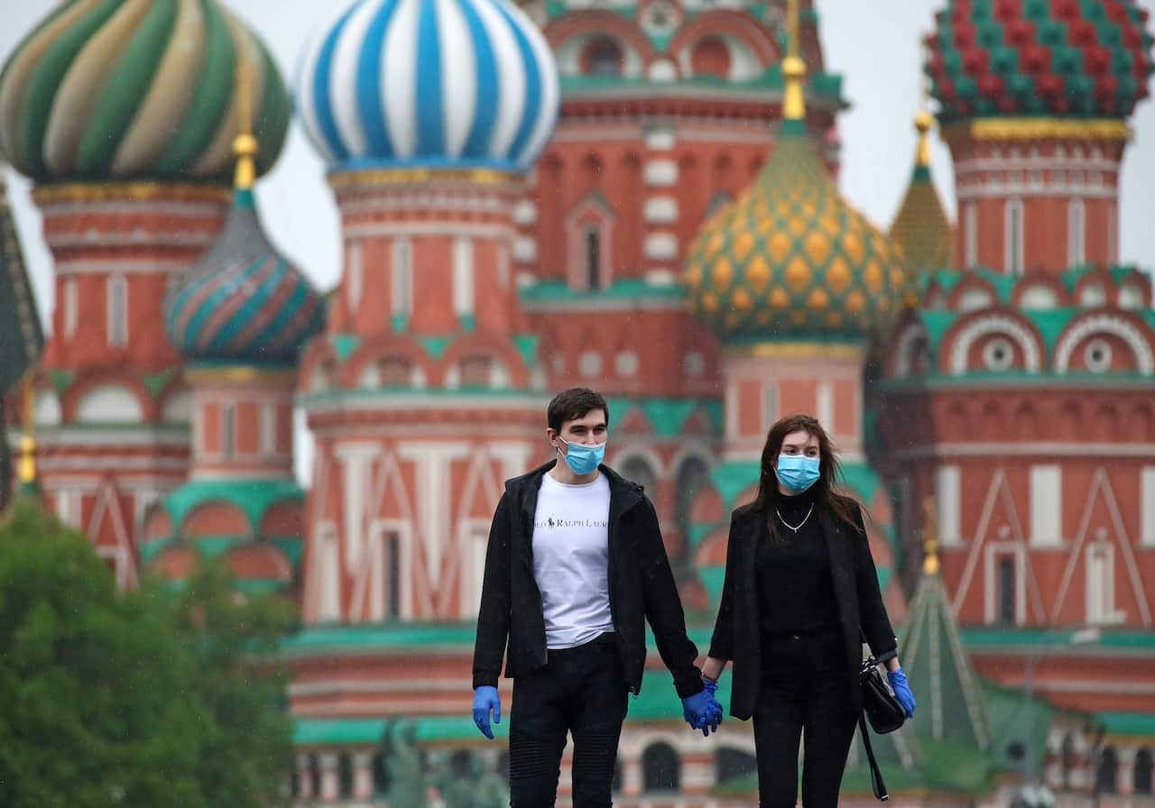 Young people hold hands as they walk in central Moscow (AAP)