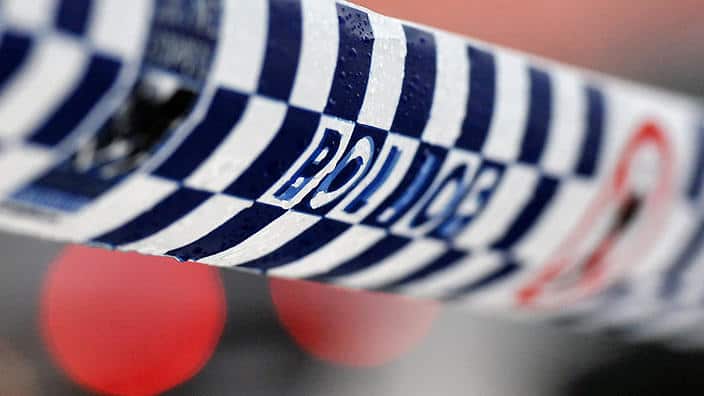 Police tape restricts access to a crime scene 