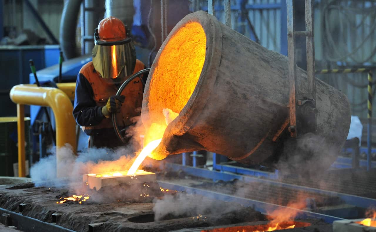 A factory worker pours molten iron at Backwell IXL in Geelong in Geelong, Wednesday, April 30, 2014. (AAP Image/Julian Smith) NO ARCHIVING
