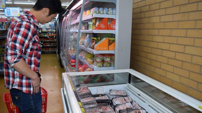 A Korean man shops in the new Asian food section
