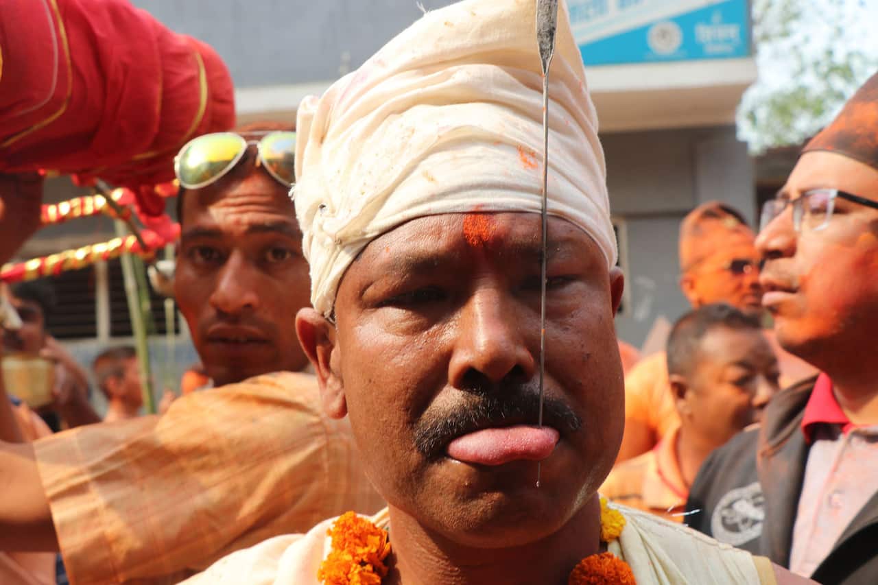 A Nepali man pierces his tongue during festival in Bhaktapur, Nepal