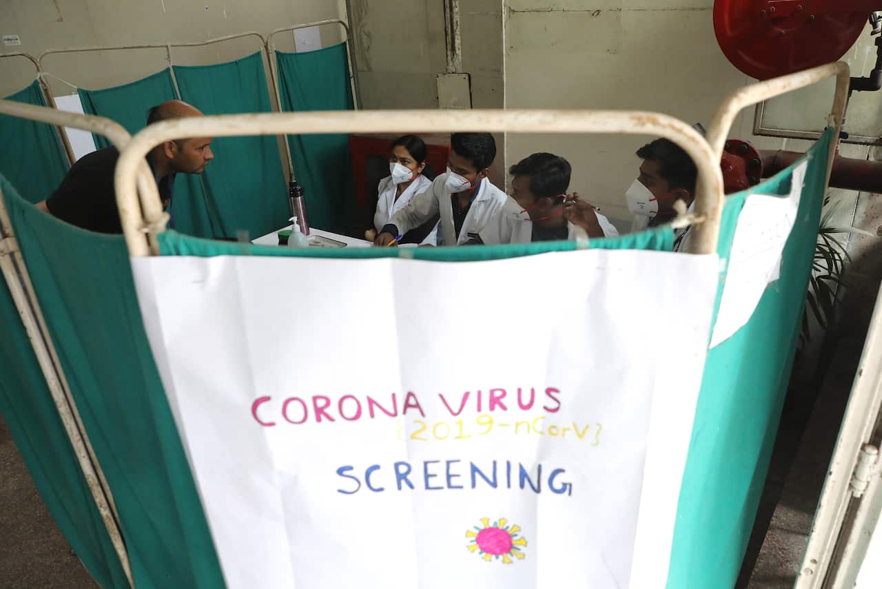 Indian doctors screen patients for Coronavirus at  Nehru Homoeopathic Medical College and Hospital in New Delhi, India, March 2020.
