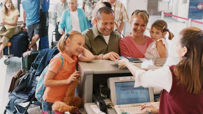 Family With Two Young Children Checks in at an Airport