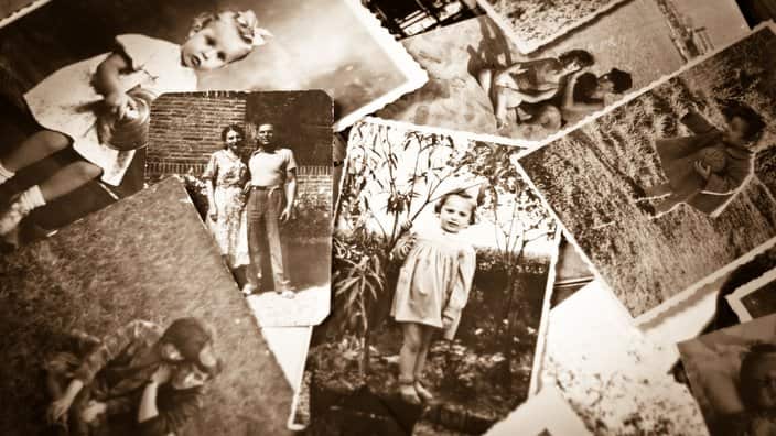 A pile of old black and white photographs