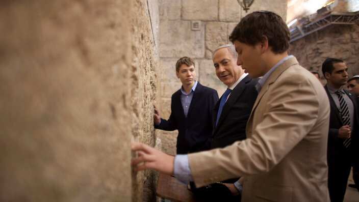 Israeli Prime Minister Benjamin Netanyahu, center, prays with his sons Yair Netanyahu left, and Avner Netanyahu