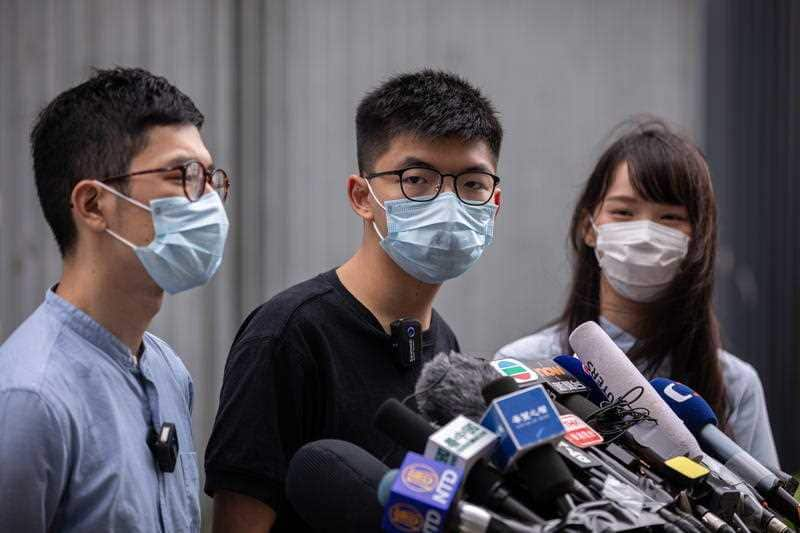 Members of the pro-democracy political group Demosisto, Nathan Law, (L), Joshua Wong, (C), and Agnes Chow, (R) outside the Legislative Council in Hong Kong