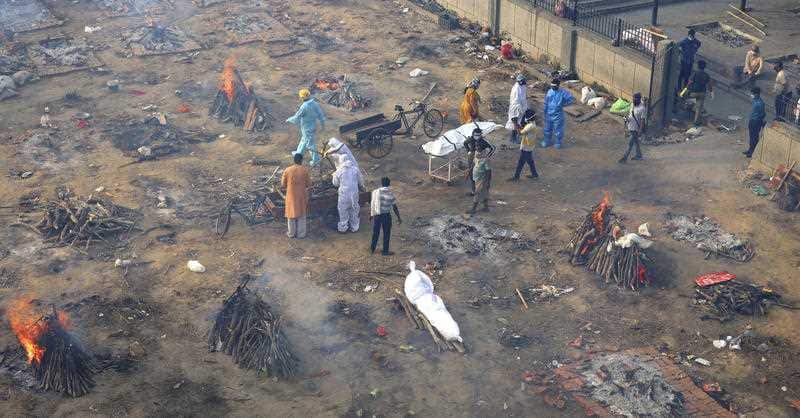 Multiple funeral pyres are seen in New Delhi for people who died of COVID-19