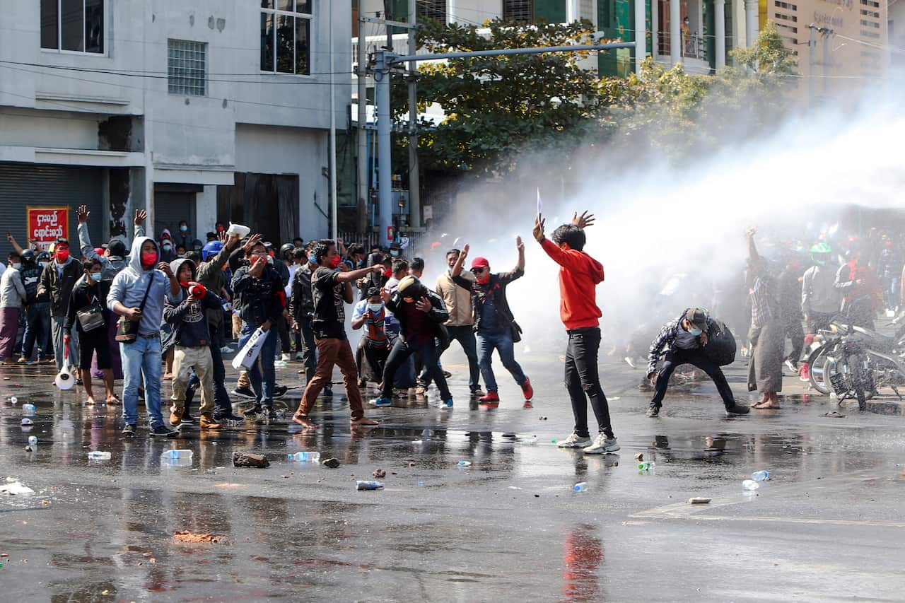 Police use water-cannon to disperse demonstrators  during a protest in Mandalay, Myanmar.
