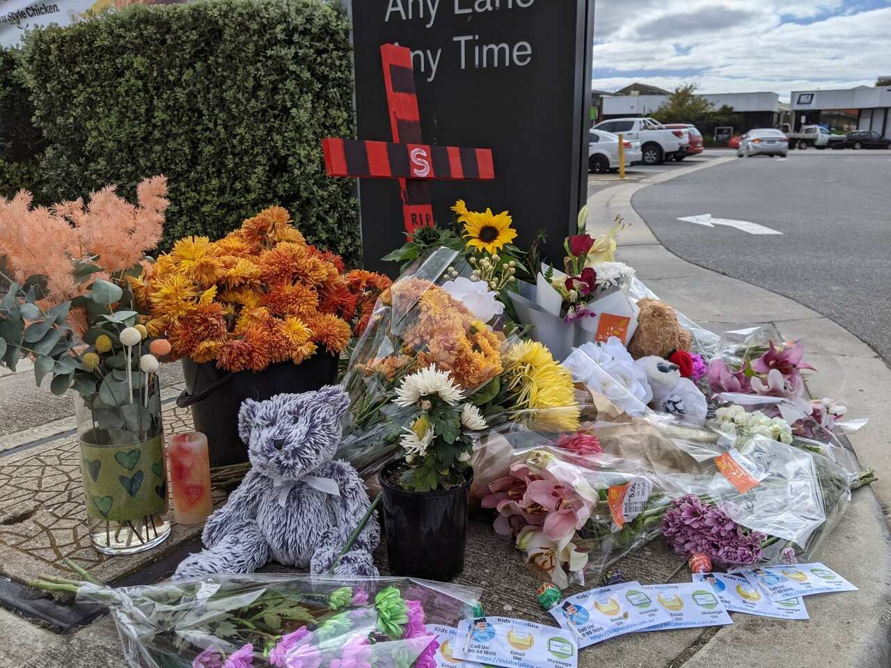 Friends of the boy lay flowers at the scene where he died
