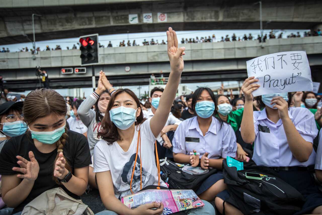 A pro-democracy protester seen making the three finger salute during an anti-government demonstration in the Thai capital.