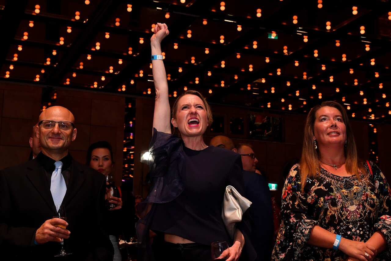 Liberals cheer as results show the Coalition on track to retain power.  