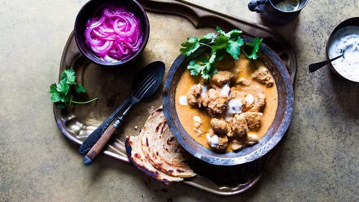 Butter chicken with mint yoghurt and pickled onions