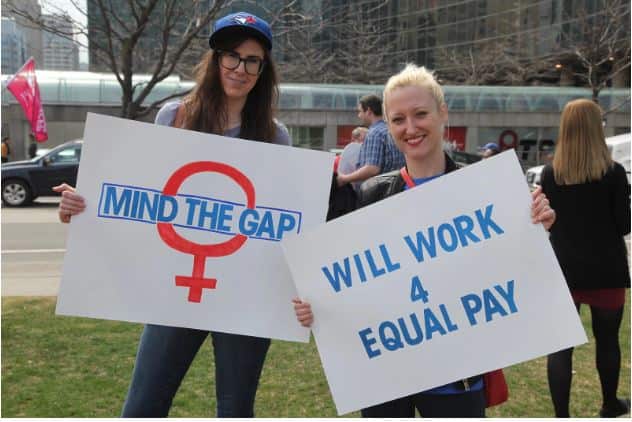 The gender pay gap affects women around the world. Pictured are women rallying to demand equal pay in Toronto, Canada.