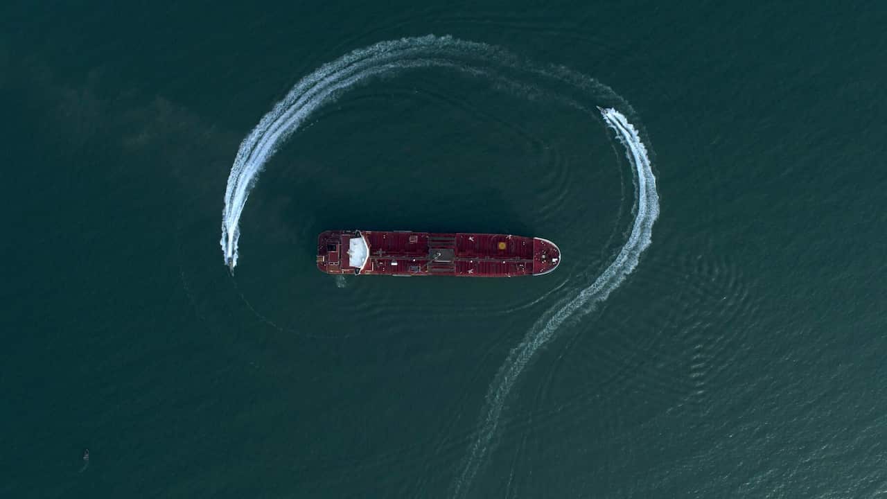 Speedboats from Iran's Revolutionary Guard circle a British-flagged oil tanker after it was seized in the Strait of Hormuz
