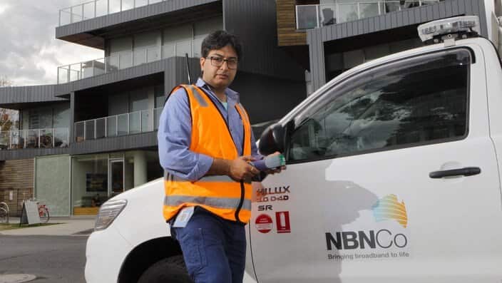 NBN technician in front of an apartment block that has been connected to the National Broadband Network (NBN) in Brunswick, Melbourne