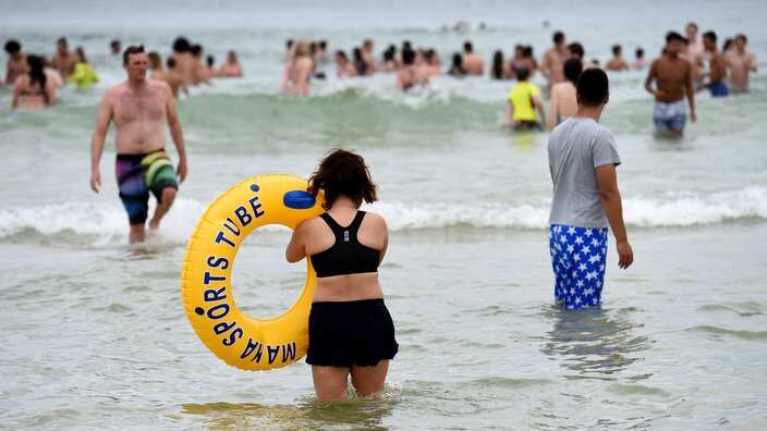 People gather in the water at Bondi Beach in Sydney