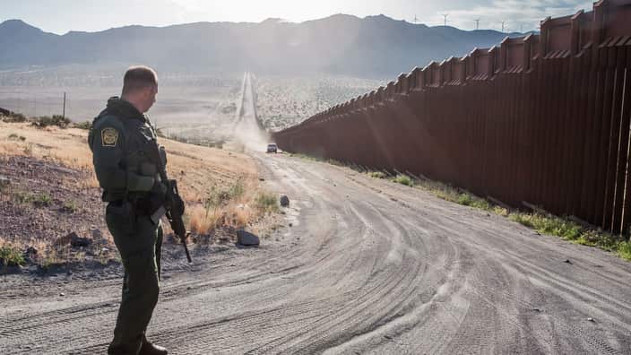 As the sun rises over the mountains, a United States Customs and Border Protection agent searches for illegal activity at the United States and Mexico border.