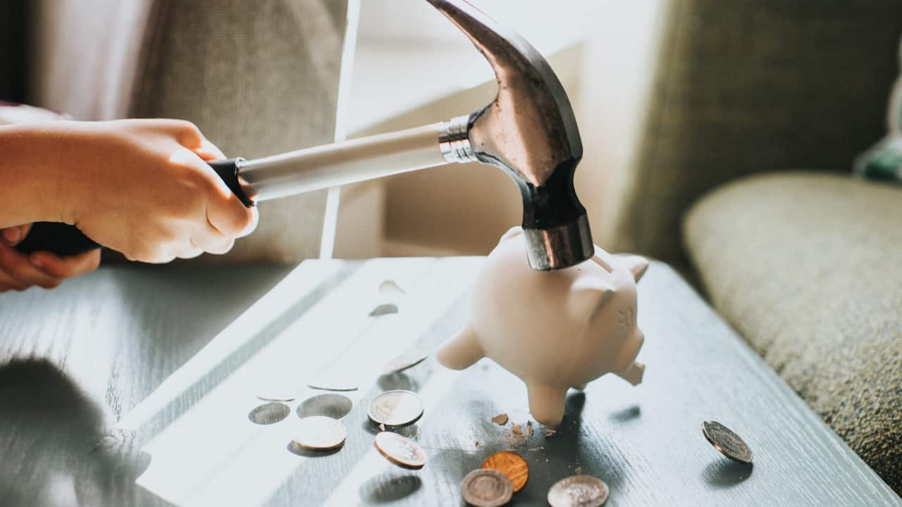 Breaking piggy bank, is it an act of desperation?  Getty Images/Catherine Falls