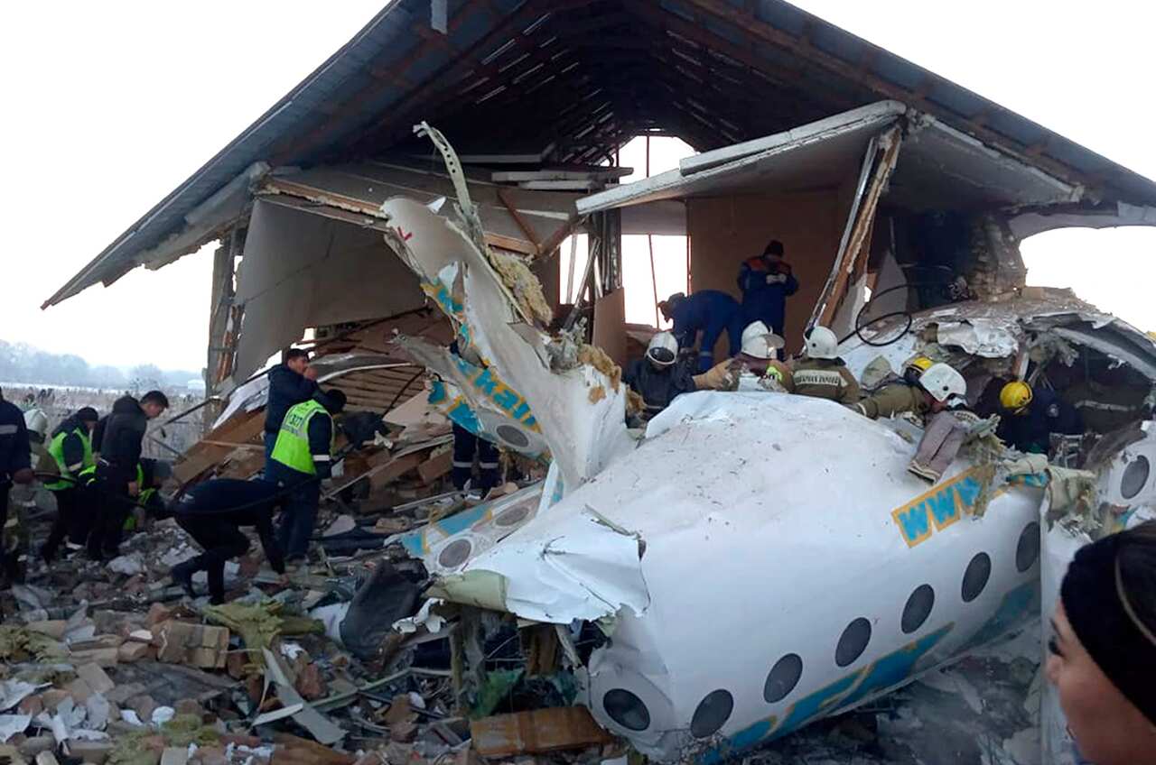 Rescuers get to work at a plane crash near Almaty International Airport, outside Almaty, Kazakhstan.