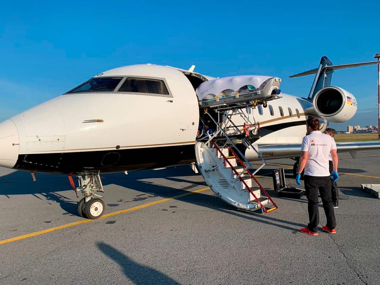Medics upload Alexei Navalny into a German special medical plane at the airport in Omsk, Russia.