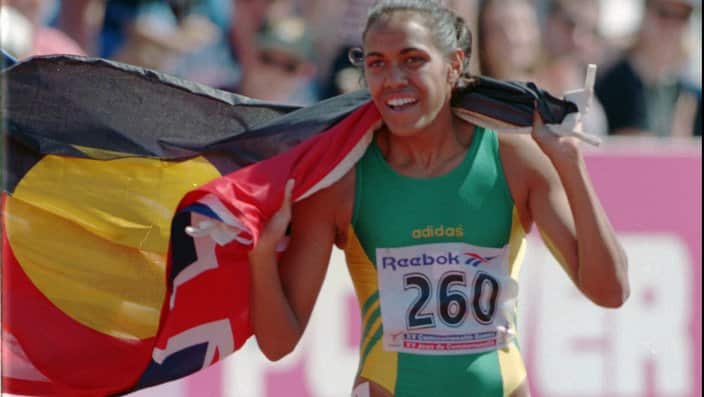 Australian Aboriginal athlete Cathy Freeman waves to the crowds after winning the women's 200mt final at The Commonwealth Games in Canada, 1994