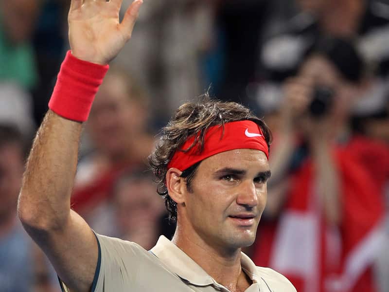Roger Federer of Switzerland waves at the crowd after he beat Marinko Matosevic of Australia 6-1, 6-1in their quarterfinal match during the Brisbane International tennis tournament in Brisbane, Australia, Friday, Jan. 3, 2014. (AP Photo/Tertius Pickard)