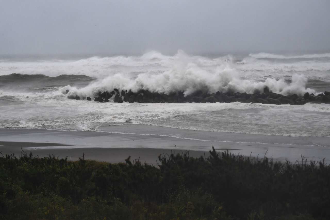 Strong waves hit a seawall along the coast in Hamamatsu.