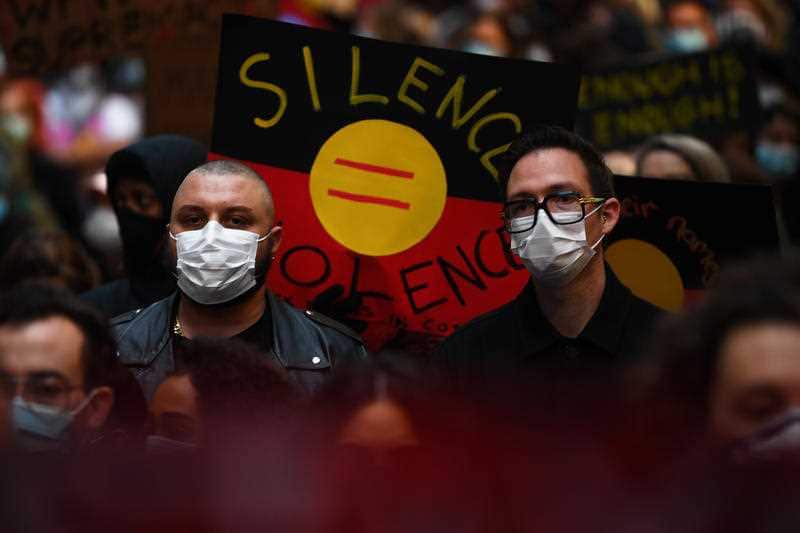 Many protesters, including these two in Melbourne, wore face masks.