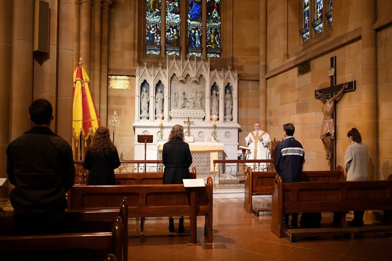 Dean of the Cathedral, Father Don Richardson gives mass at St Mary's Cathedral in Sydney, Friday, May 15, 2020.