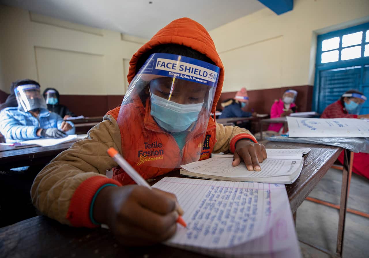 Students of Yuba Pratibha School in Nepal, wearing a face shield and masks at school during a coronavirus pandemic in Kathmandu, Nepal, 26 November 2020. The head Teacher of Yuba Pratibha School,  Yanga Raj Dahal, started to conduct classes for student