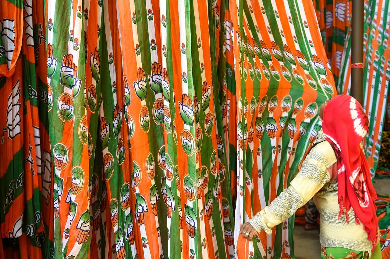 Worker dries colourful materials dedicated to the Congress Party campaigns ahead of India's general election, Ahmedabad on March 11, 2019. 