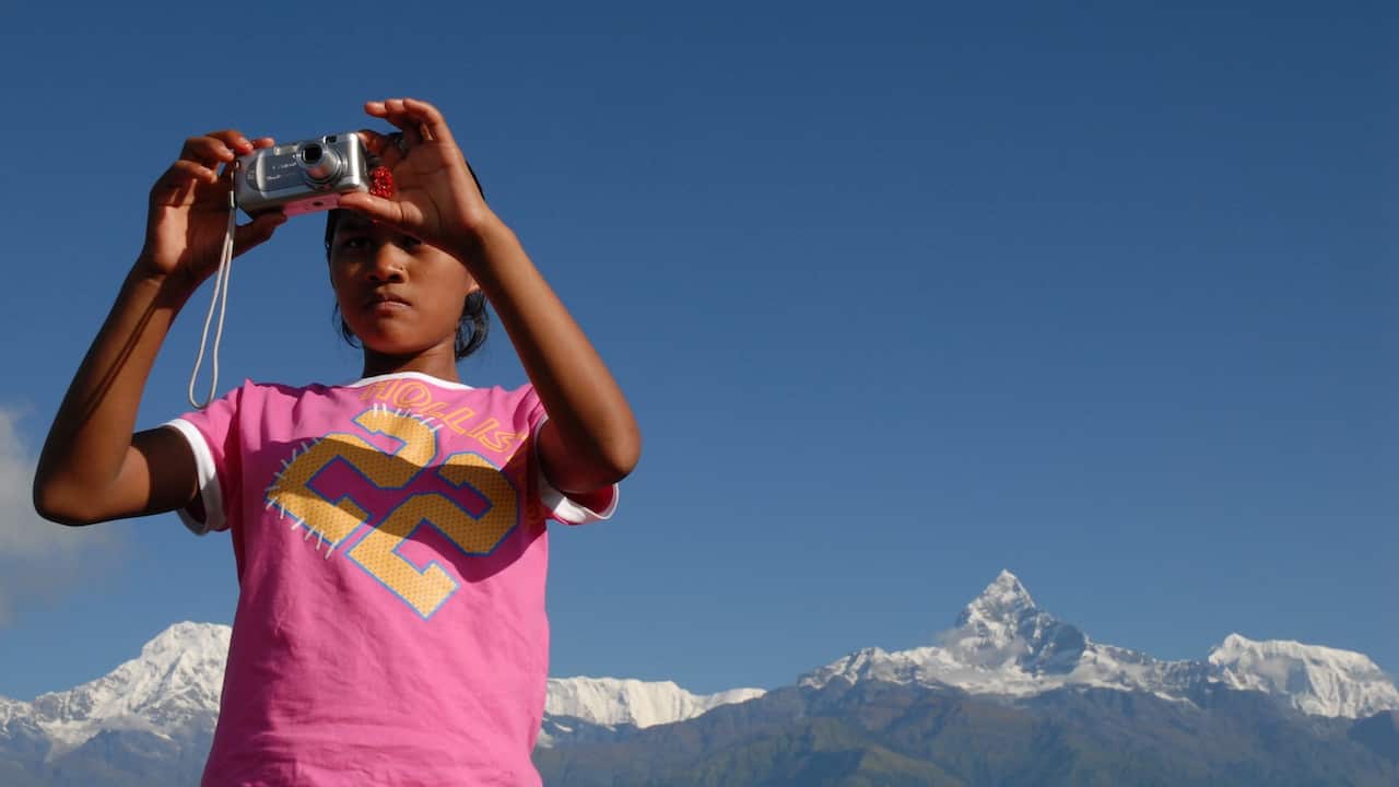 Belmaya Nepali as a 14-year-old in 2006 at Sarangkot, with Machhapchhre peak and Annapurna range near Pokhara, Nepal.
