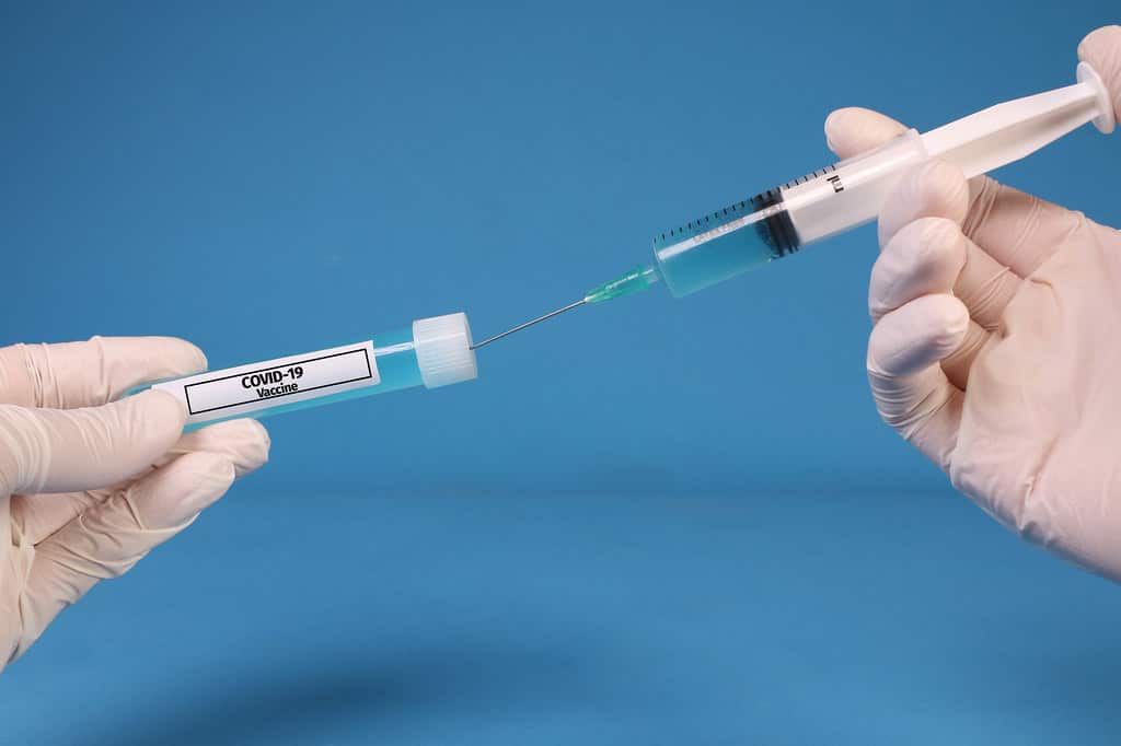Doctor or nurse filling a syringe. 