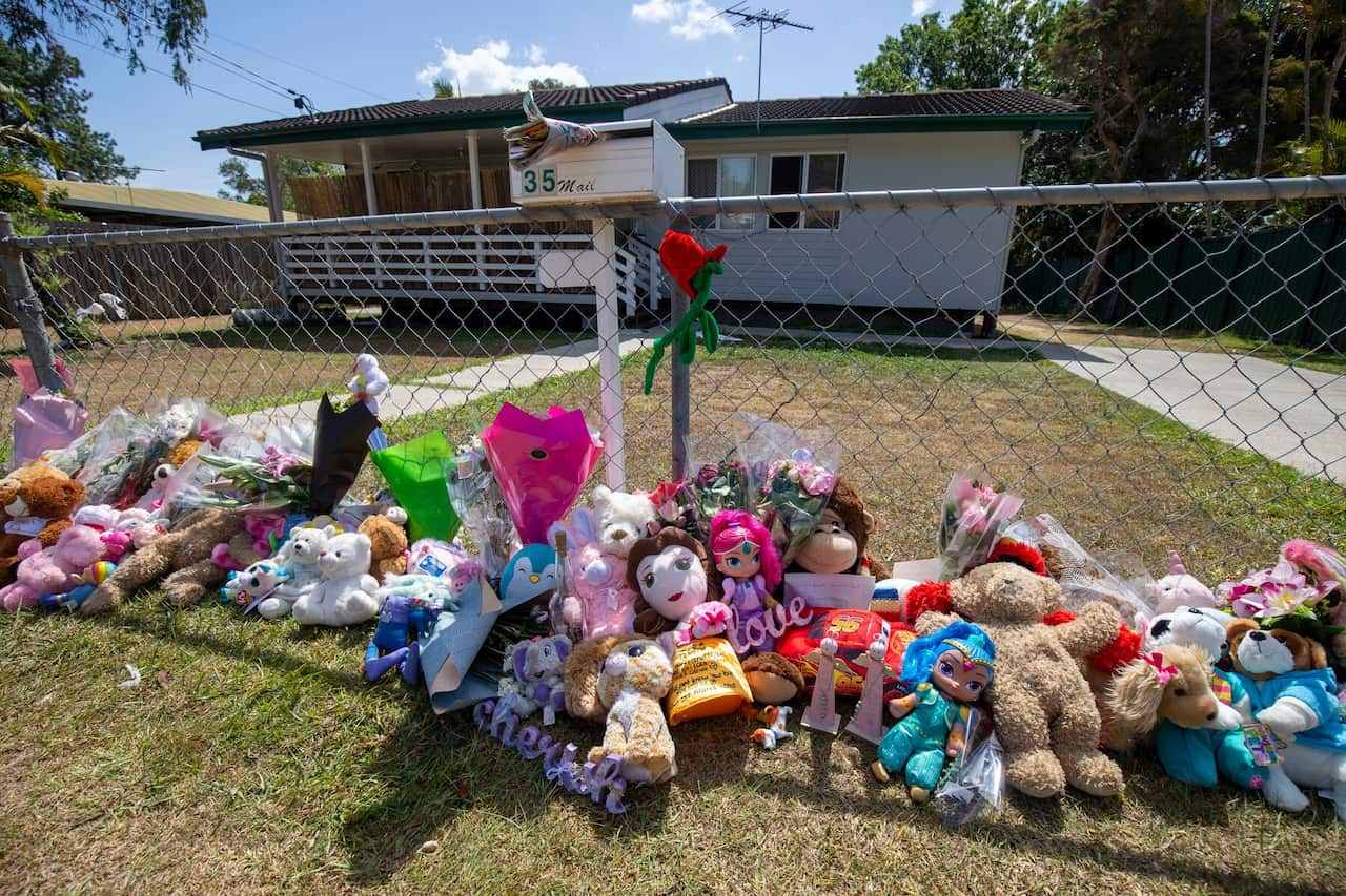 Tributes at the Brisbane house where two little girls died in a hot car parked outside in November 