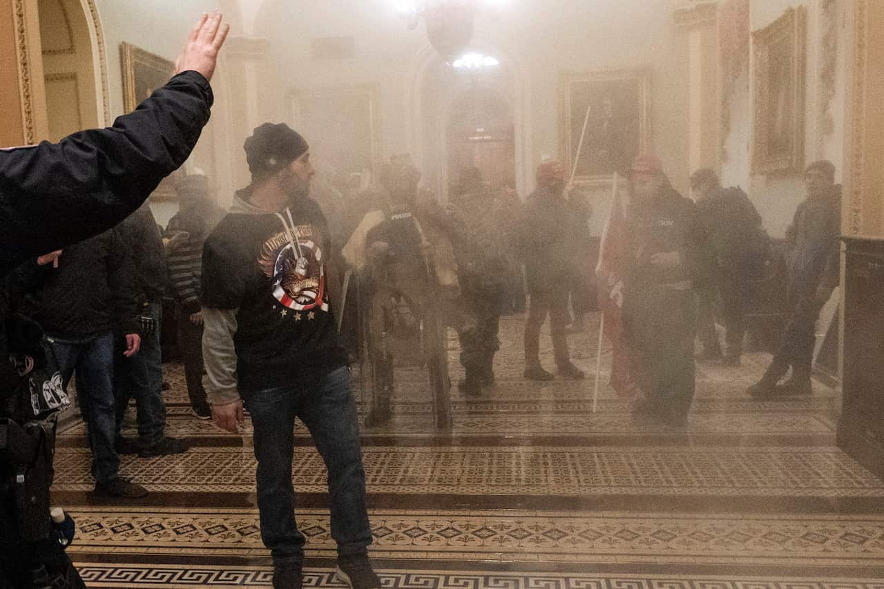 A man with a QAnon jumper during the 6 January 2021 Capitol riot
