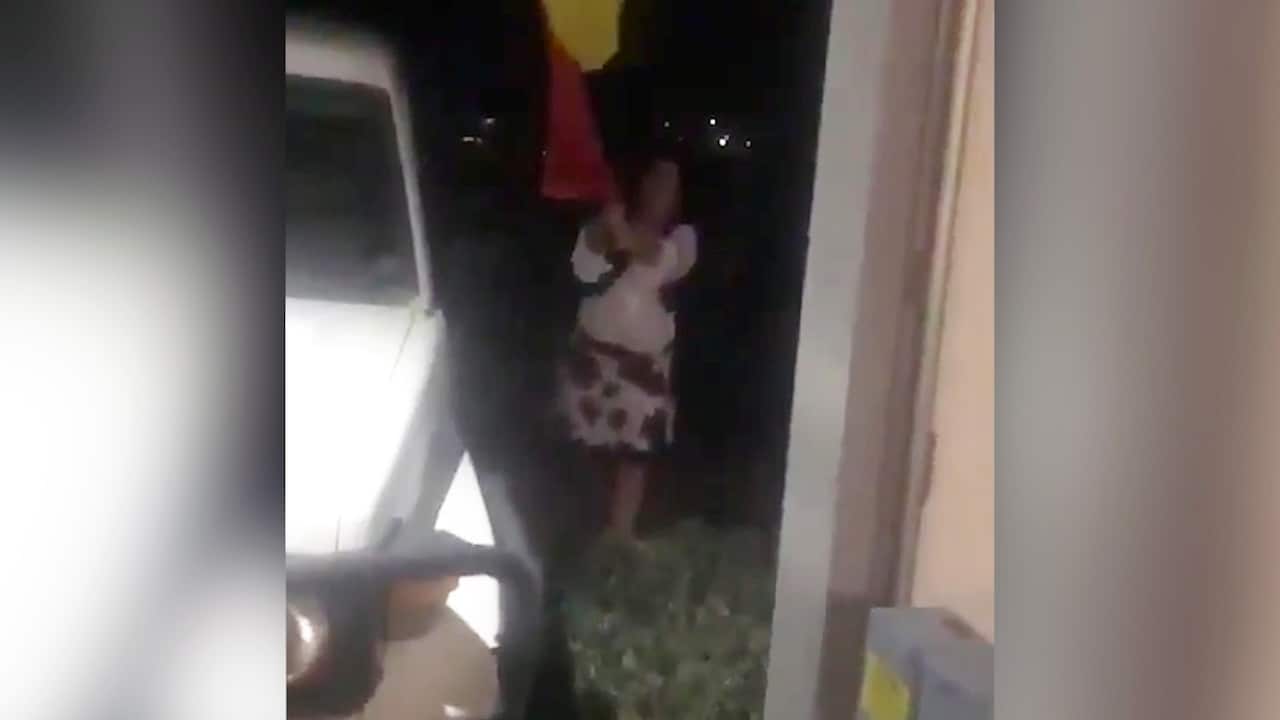 Karen (pictured) trying to tear down an Aboriginal flag on a Mildura property.