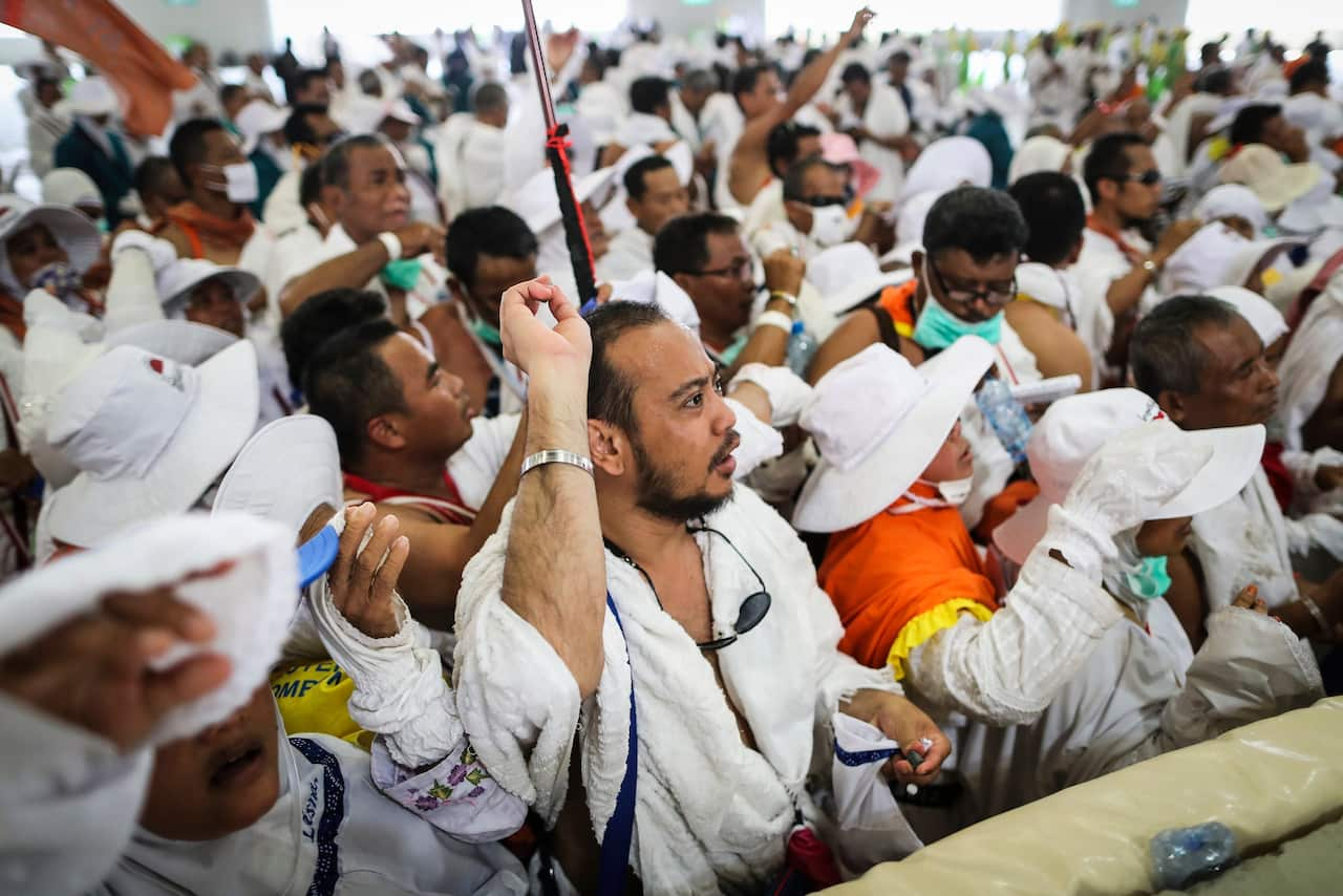 Muslim worshippers from Indonesia throw pebbles as part on the symbolic al-A'qabah at the Jamarat Bridge during the Hajj pilgrimage in Mina, near Mecca.