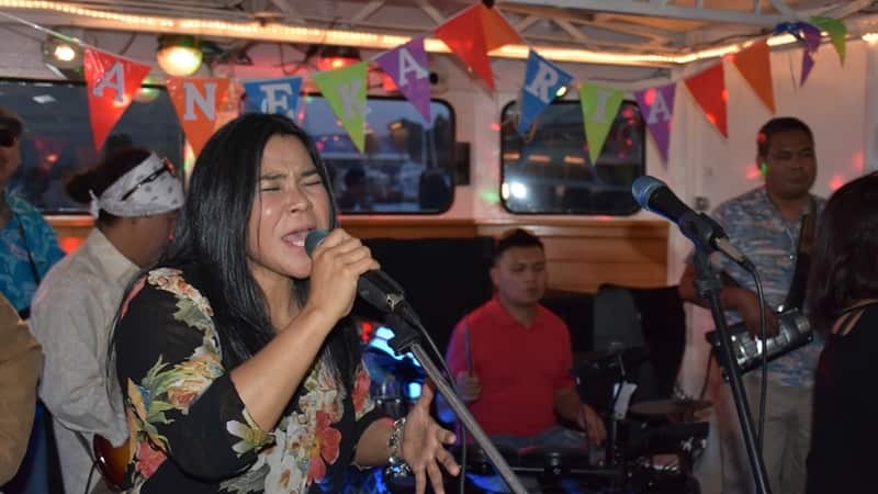 Norida singing to her appreciative audience on board of the Calypso Lady, on their sunset cruise along the Yarra, Melb 24 Nov 2019.