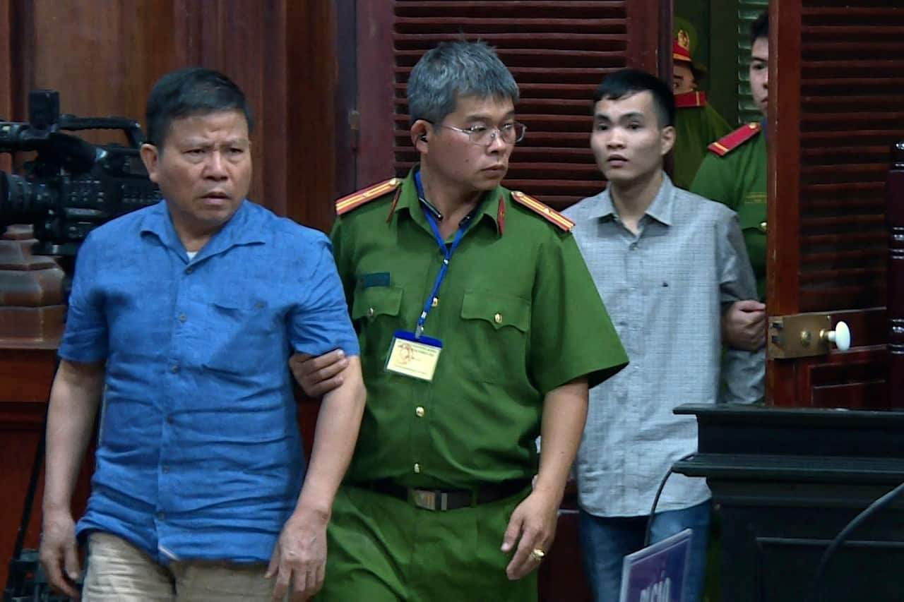 Australian man Chau Van Kham is escorted into a court room in Ho Chi Minh city, Vietnam this week.