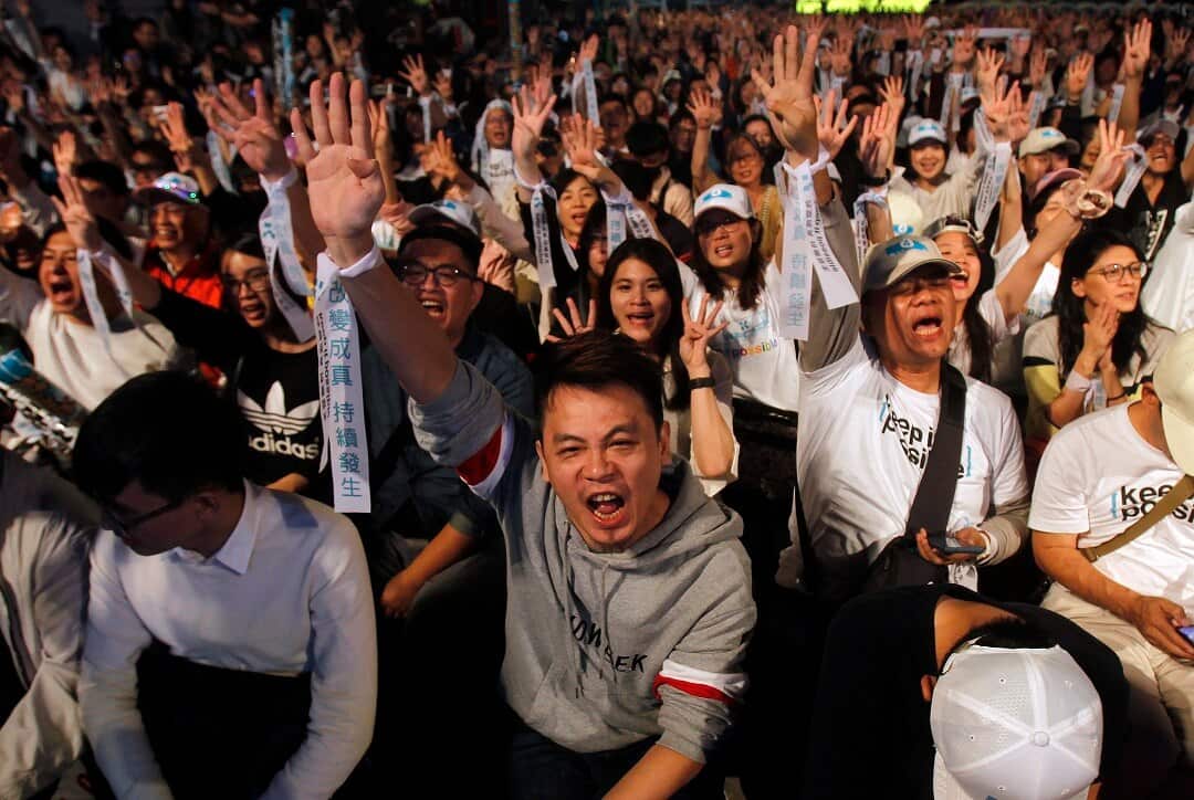 Supporters of Taipei city mayor and city mayoral candidate Ko Wen-je cheer in Taipei, Taiwan, Saturday.