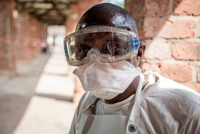 A health worker wears protective clothing outside an isolation ward to diagnose and treat suspected Ebola patients, at Bikoro Hospital.