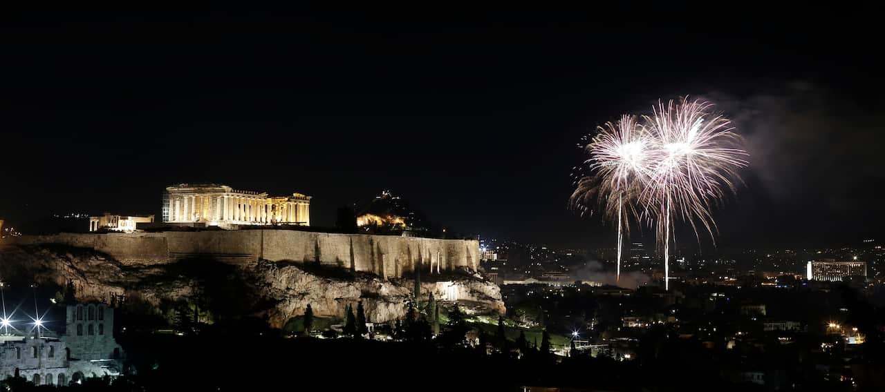 Fireworks illuminate the Athenian sky as the temple of Parthenon sits atop the Acropolis hill during the New Year celebrations in Athens Greece, 01 January 2020.
