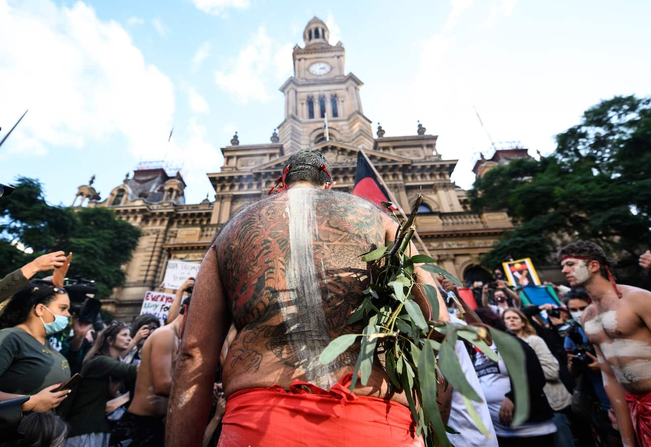Aboriginal Elders participating in a traditional smoke ceremony in front of Sydney Town Hall at the Black Lives Matter rally in Sydney.