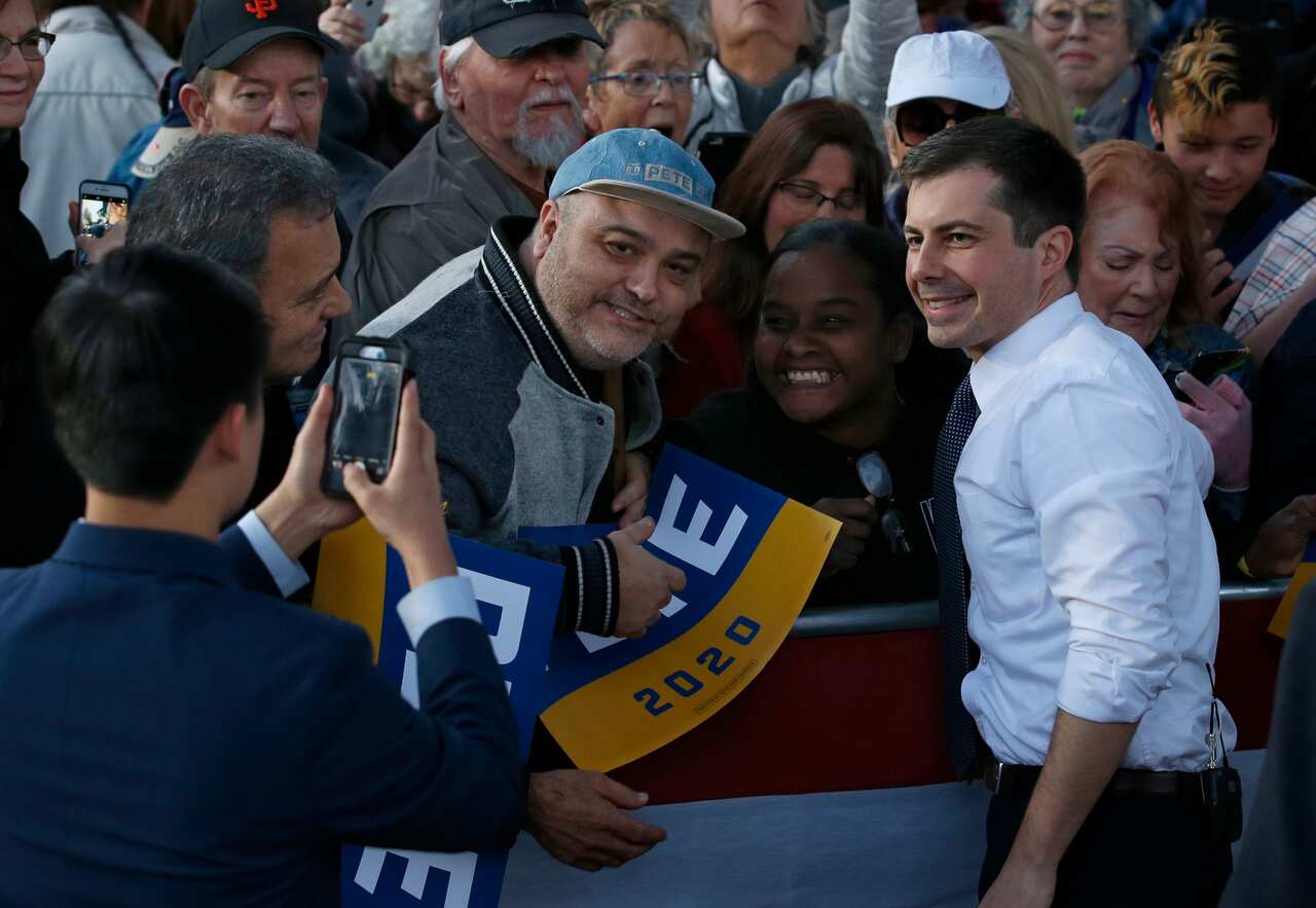 Democratic presidential candidate and former South Bend Mayor Pete Buttigieg poses for photos with supporters during a town hall rally in Sacramento, Californa.