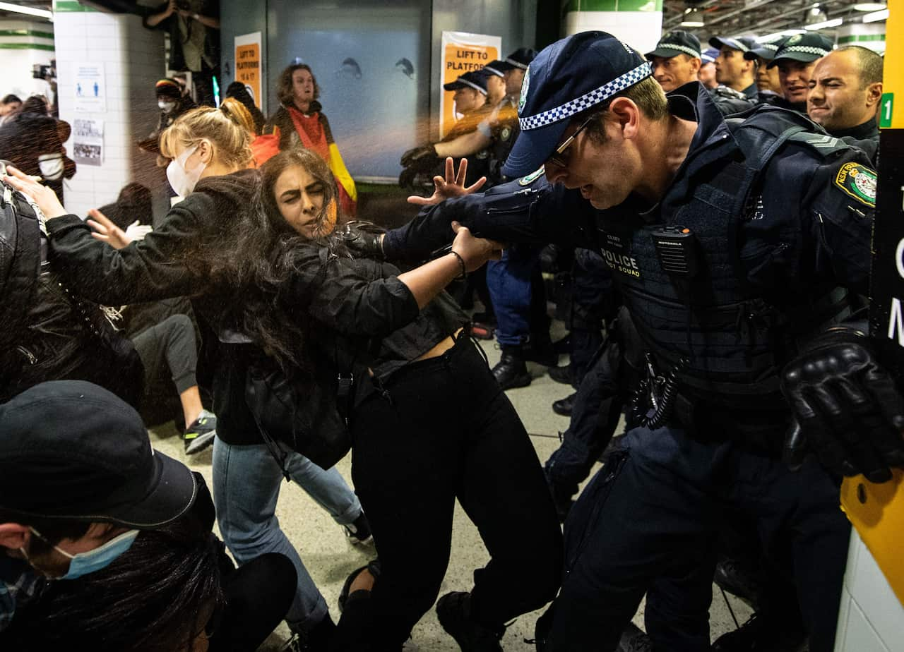 Police spraying protesters with pepper spray inside Central Station after a Black Lives Matter rally in Sydney, Saturday, June 6, 2020.