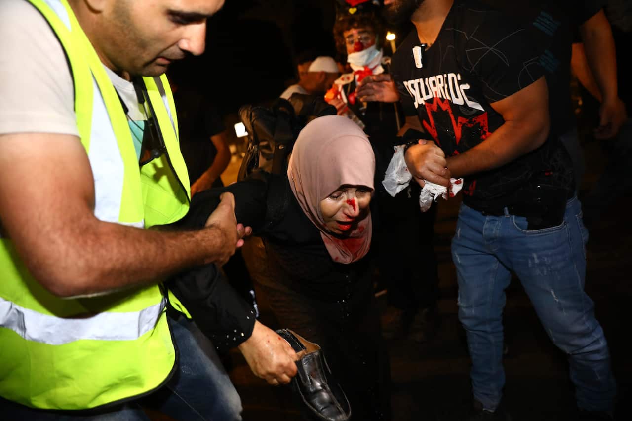 An injured Palestinian demonstrator is helped during clashes at Damascus Gate just outside Jerusalem's Old City, Saturday, 8 May, 2021.