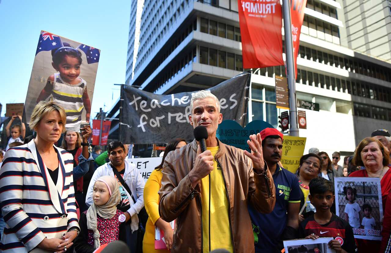SBS commentator Craig Foster speaks to the crowd during the 'Let Them Stay! Emergency Rally' for the family in September. 