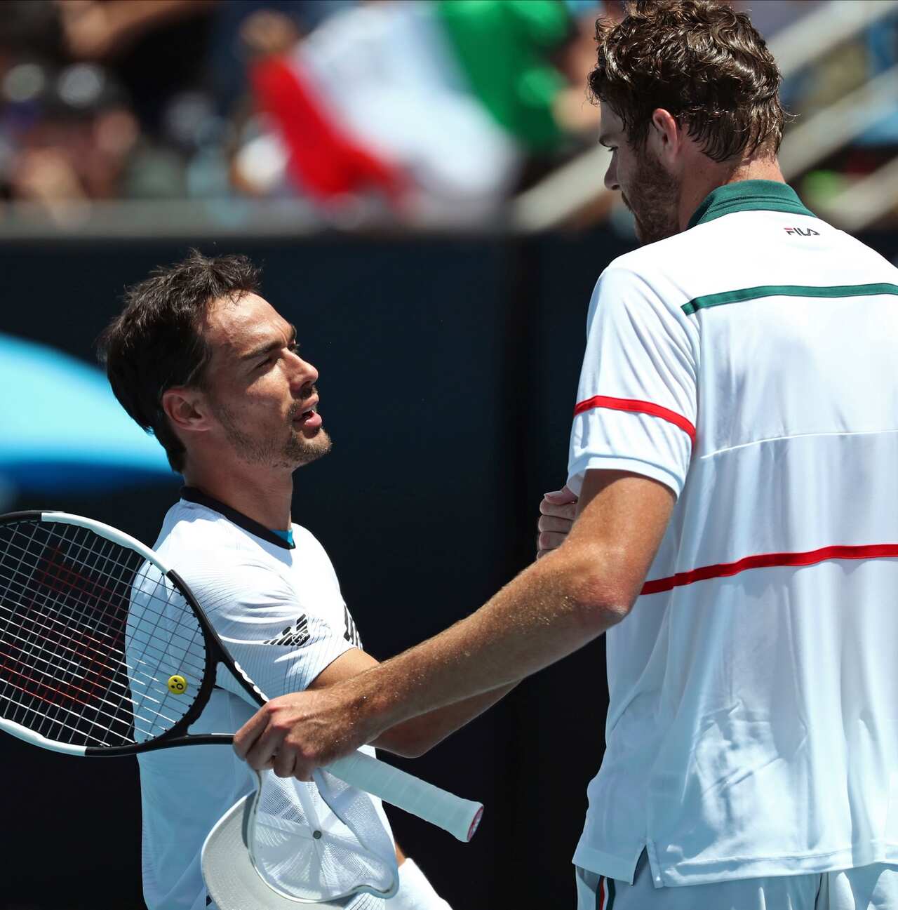 Italy's Fabio Fognini, left, is congratulated by Reilly Opelka of the U.S. after winning their first round singles match at the Australian Open tennis championship in Melbourne, Australia, Tuesday, Jan. 21, 2020. (AP Photo/Dita Alangkara)